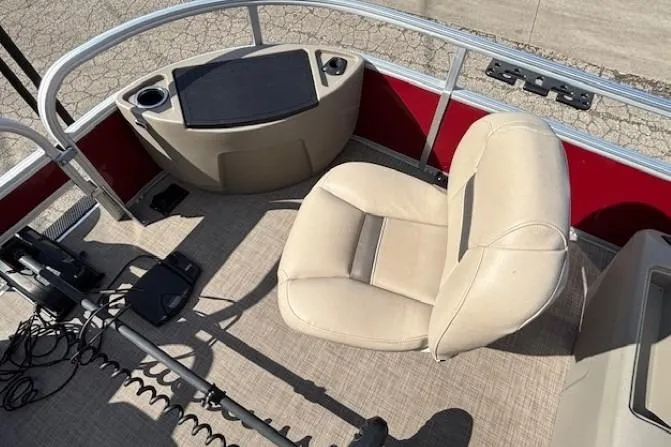 Slide: The Image of 2022 Sun Tracker Bass Buggy 18 DLX interior with beige seating and control panel. - 7