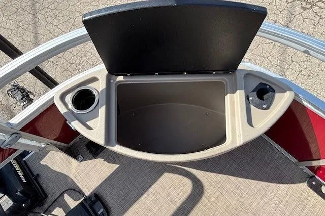 Slide: The Image of 2022 Sun Tracker Bass Buggy 18 DLX boat storage compartment with cup holders. - 8