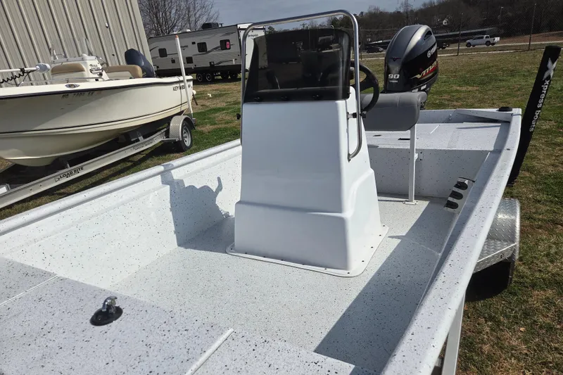 Slide: The Image of 2020 Xpress XP18CC boat with center console and Yamaha engine, parked outdoors. - 10