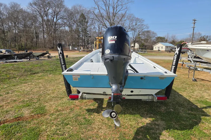 Slide: The Image of 2020 Xpress XP18CC boat with 90HP engine, parked on grass. - 3