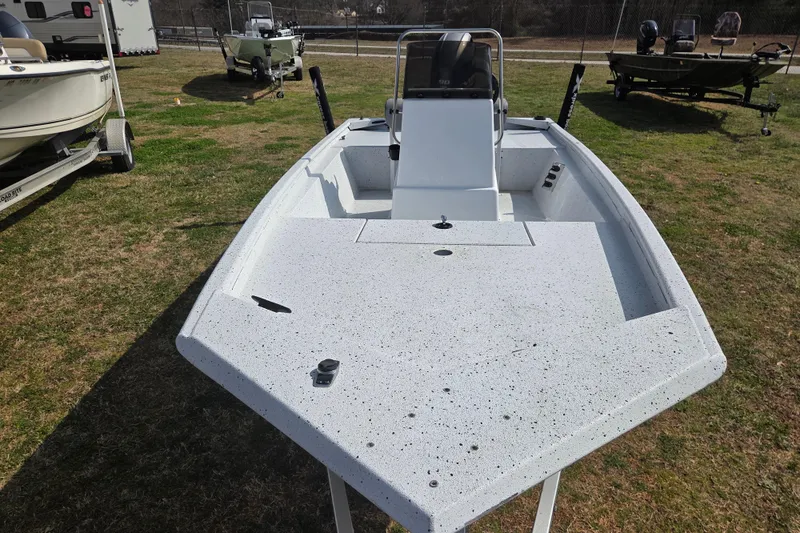 Slide: The Image of 2020 Xpress XP18CC boat on grass, showcasing spacious deck and console. - 5