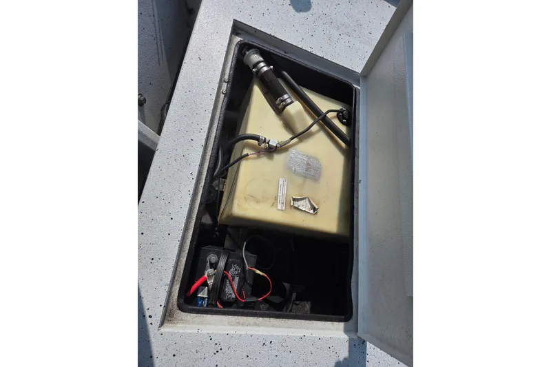 Slide: The Image of 2020 Xpress XP18CC boat compartment with fuel tank and battery. - 6