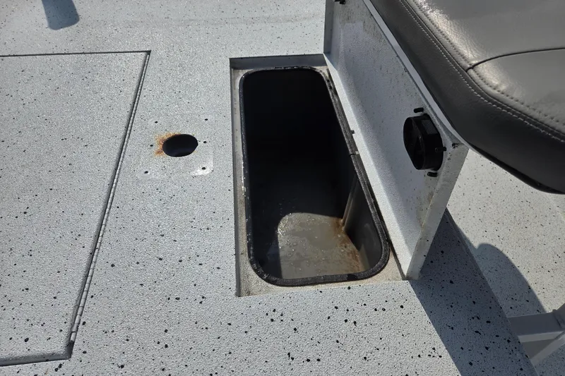 Slide: The Image of 2020 Xpress XP18CC boat interior with storage compartment and seat detail. - 7