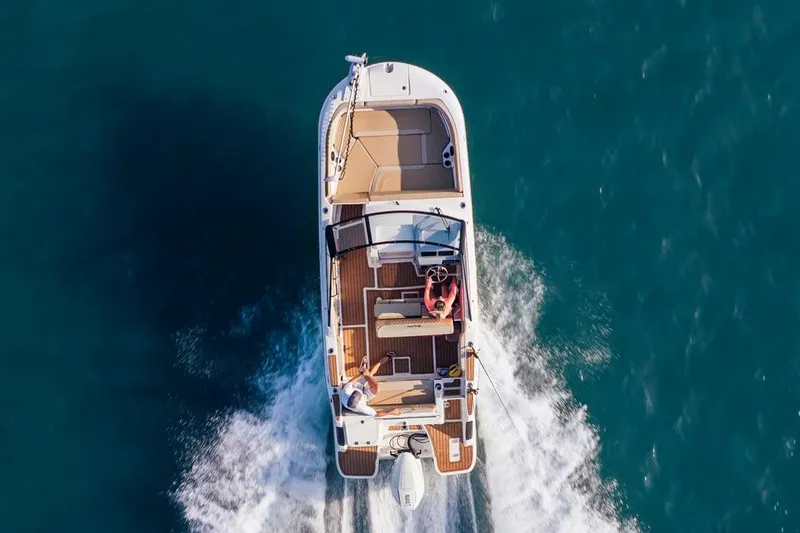 Slide: The Image of Manufacturer Provided Image: 2025 Bayliner Trophy T22SC boat cruising on open water, aerial view. - 1