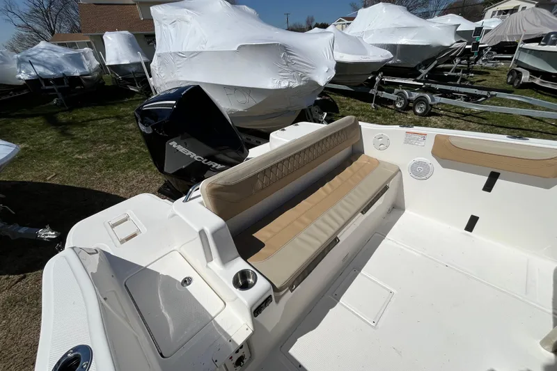 Slide: The Image of 2026 Bayliner Trophy T22SC boat interior with seating and Mercury outboard motor. - 10