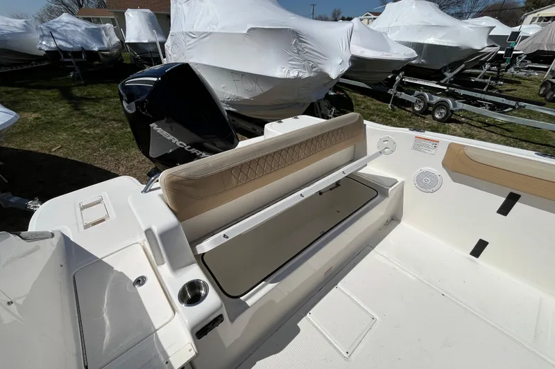 Slide: The Image of 2026 Bayliner Trophy T22SC boat interior with Mercury engine, featuring seating and storage. - 11