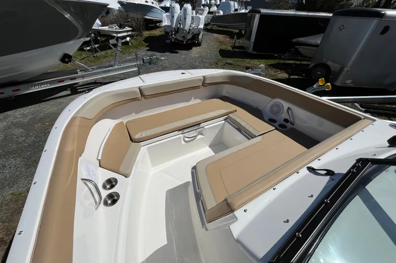 Slide: The Image of 2026 Bayliner Trophy T22SC boat interior with tan seating and cup holders. - 5