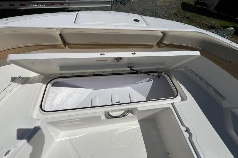 Slide: The Image of Open storage compartment on 2026 Bayliner Trophy T22SC boat, showcasing spacious interior design. - 8