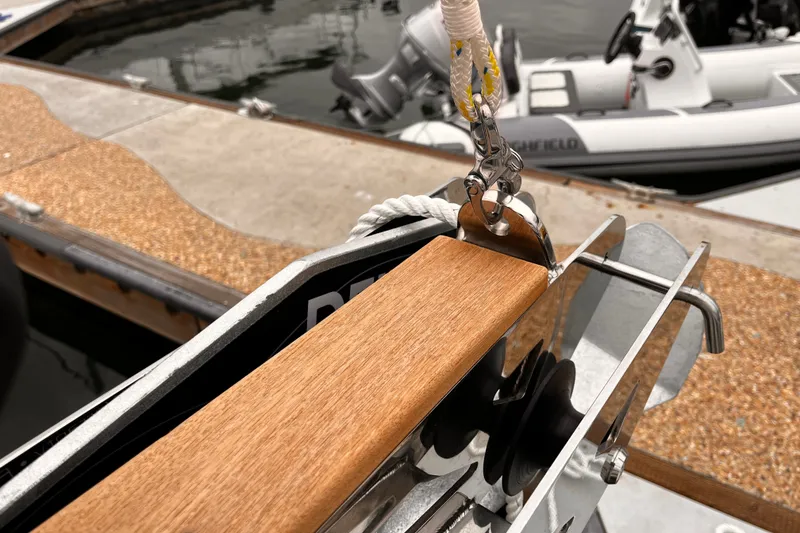 Slide: The Image of Close-up of 2023 Hanse 388 yacht's anchor mechanism at a marina dock. - 35