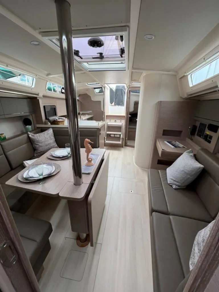 Slide: The Image of Modern interior of 2023 Hanse 388 yacht with dining area and cozy seating. - 19