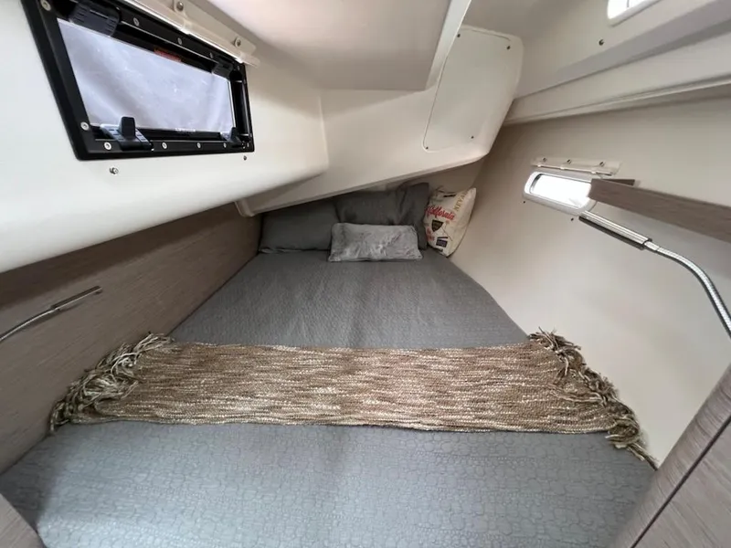 Slide: The Image of Cozy cabin interior of 2023 Hanse 388 sailboat with bed and window. - 29