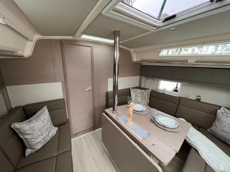 Slide: The Image of Interior of 2023 Hanse 388 sailboat with modern dining area and skylight. - 18