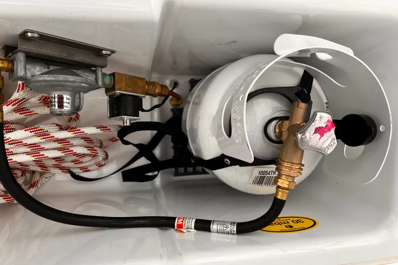 Slide: The Image of Propane tank setup in a 2023 Hanse 388 yacht, featuring secure connections and safety components. - 38