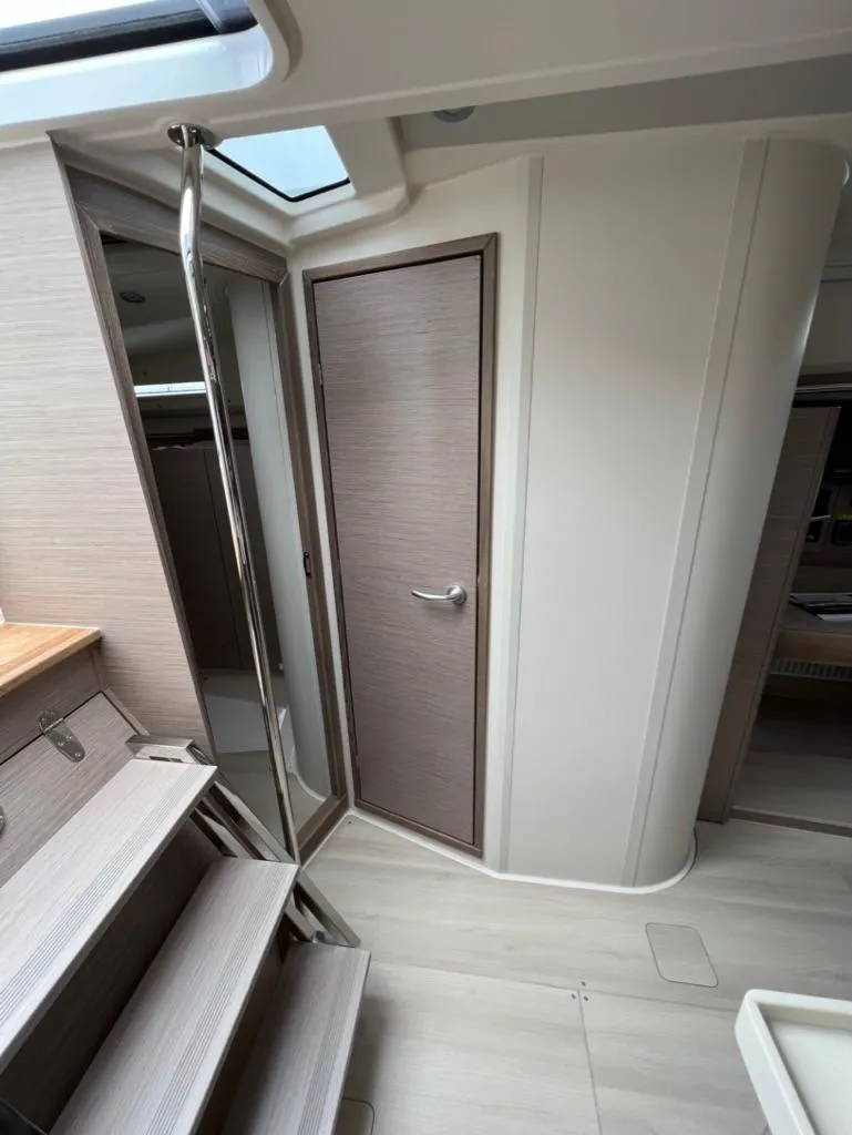 Slide: The Image of Interior of 2023 Hanse 388 yacht, featuring modern wooden finishes and sleek design. - 15