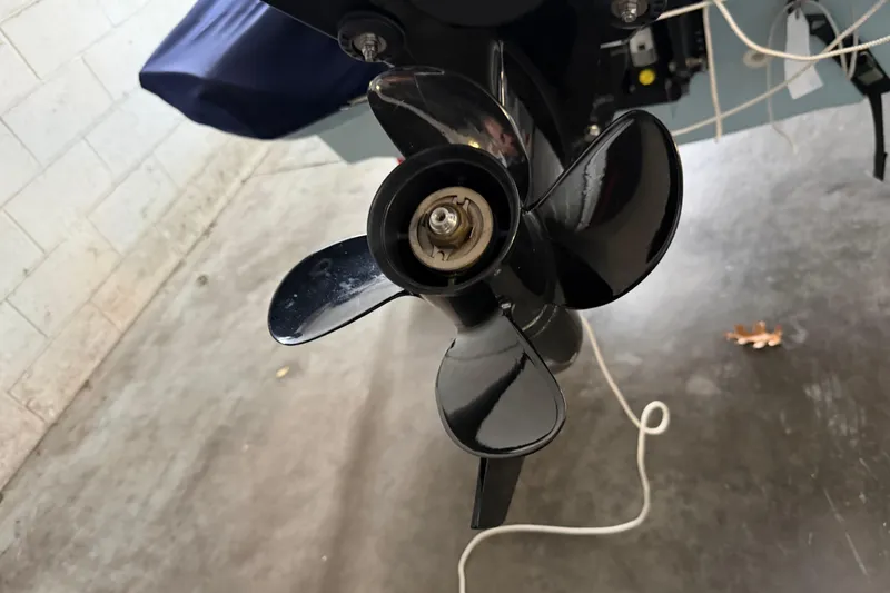 Slide: The Image of 2023 Boston Whaler 130 Super Sport boat propeller in a garage setting. - 10