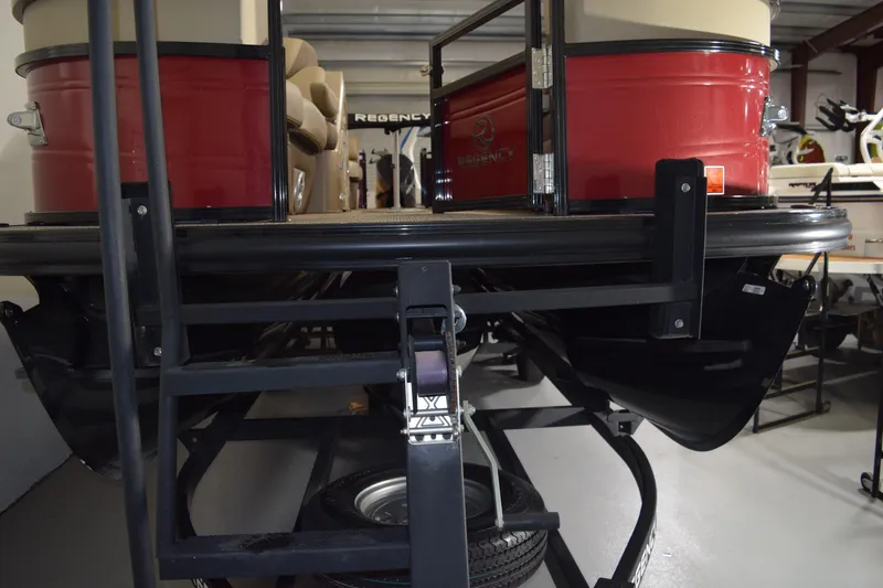 Slide: The Image of 2022 Regency 230 DL3 pontoon boat on trailer in storage facility. - 13
