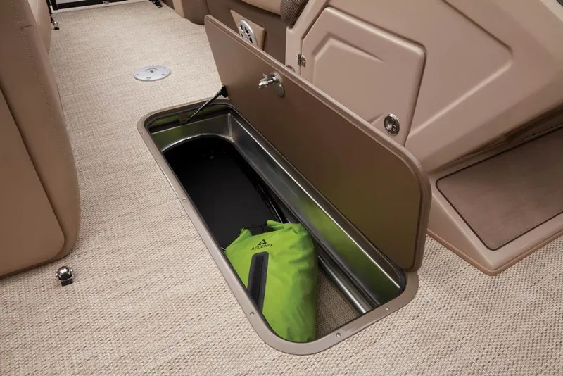Slide: The Image of Regency 230 DL3 2022 boat storage compartment with green bag. - 32