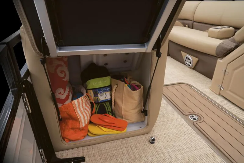 Slide: The Image of Storage compartment in Regency 230 DL3 boat filled with beach items. - 44