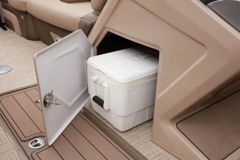 Slide: The Image of Regency 230 DL3 2022 boat with open storage compartment and cooler. - 45