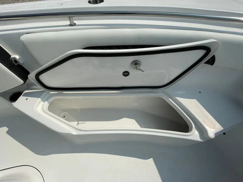 Slide: The Image of 2025 Tidewater 232 CC Adventure boat storage compartment open, showcasing interior space. - 12