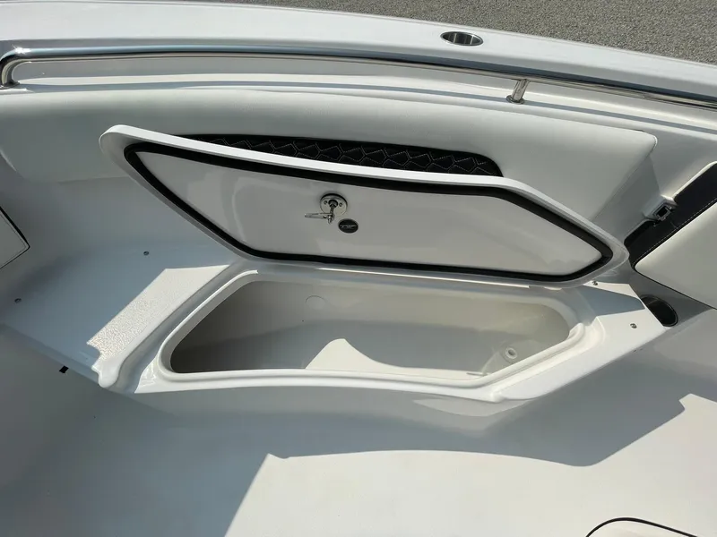 Slide: The Image of 2025 Tidewater 232 CC Adventure boat storage compartment open, showcasing interior space. - 13
