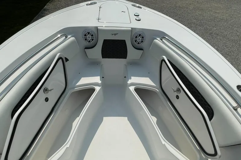 Slide: The Image of 2025 Tidewater 232 CC Adventure boat interior with storage compartments and speakers. - 14