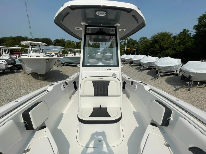 Slide: The Image of 2025 Tidewater 232 CC Adventure boat, sleek design, spacious seating, outdoor showroom display. - 16