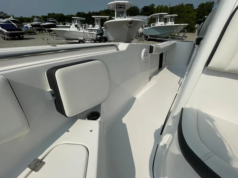 Slide: The Image of 2025 Tidewater 232 CC Adventure boat interior, showcasing sleek white seating and modern design. - 18