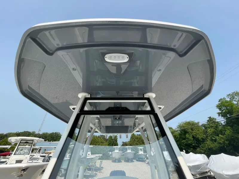 Slide: The Image of 2025 Tidewater 232 CC Adventure boat, showcasing sleek T-top design and modern features. - 19