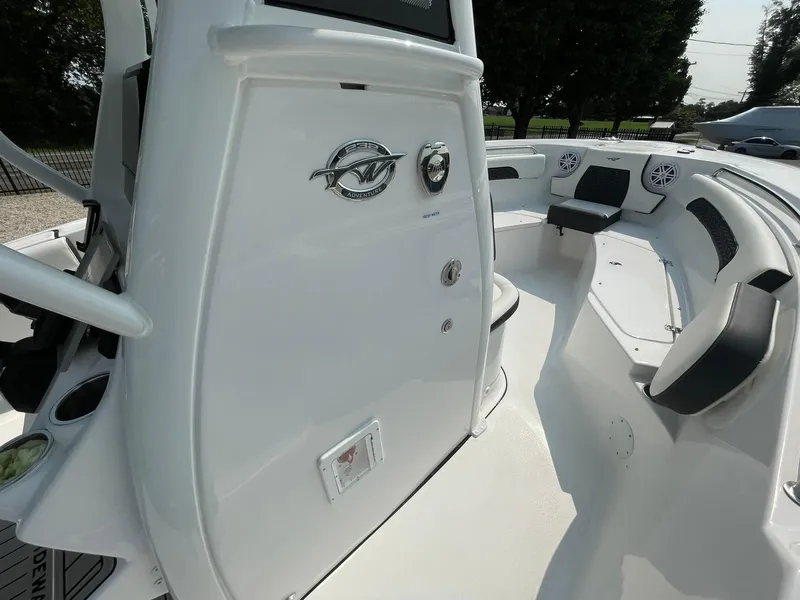 Slide: The Image of 2025 Tidewater 232 CC Adventure boat interior with seating and control panel. - 20