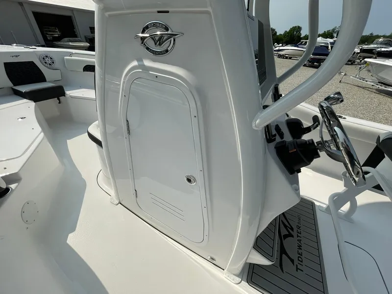 Slide: The Image of 2025 Tidewater 232 CC Adventure boat interior with steering console and seating area. - 22