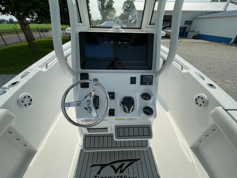 Slide: The Image of 2025 Tidewater 232 CC Adventure boat console with steering wheel and controls. - 24