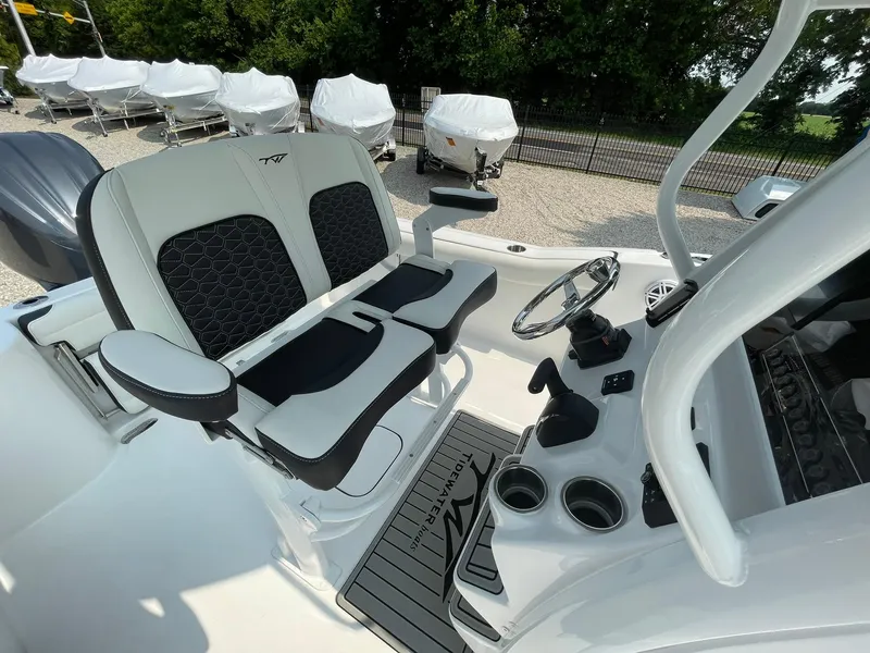 Slide: The Image of 2025 Tidewater 232 CC Adventure boat interior with dual seating and steering console. - 26
