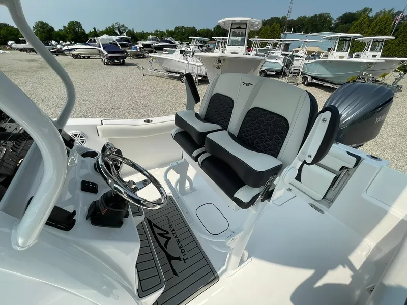 Slide: The Image of 2025 Tidewater 232 CC Adventure boat interior with dual seats and steering wheel. - 29