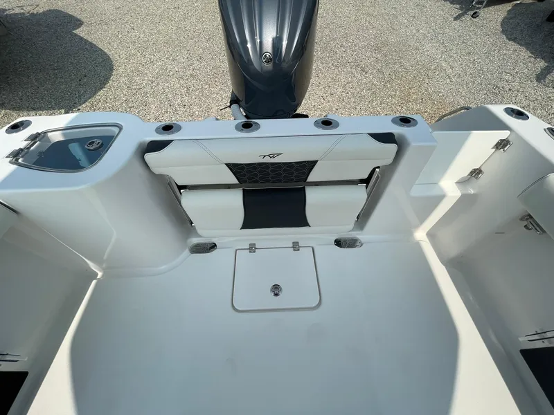 Slide: The Image of 2025 Tidewater 232 CC Adventure boat interior with seating and storage compartments. - 34