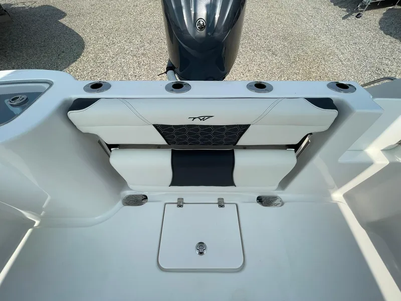 Slide: The Image of 2025 Tidewater 232 CC Adventure boat interior with seating and storage compartments. - 35