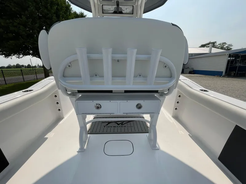 Slide: The Image of 2025 Tidewater 232 CC Adventure boat interior with rod holders and storage drawers. - 38