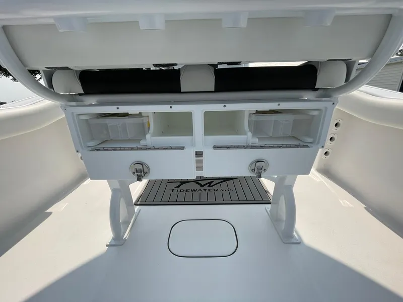 Slide: The Image of 2025 Tidewater 232 CC Adventure boat interior with storage compartments and seating. - 39