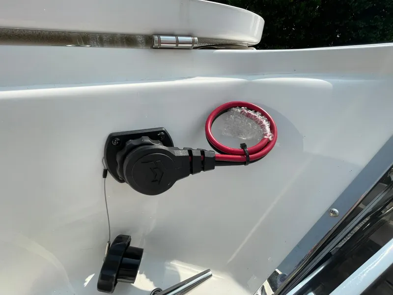 Slide: The Image of 2025 Tidewater 232 CC Adventure boat detail with electrical plug and red wiring. - 4