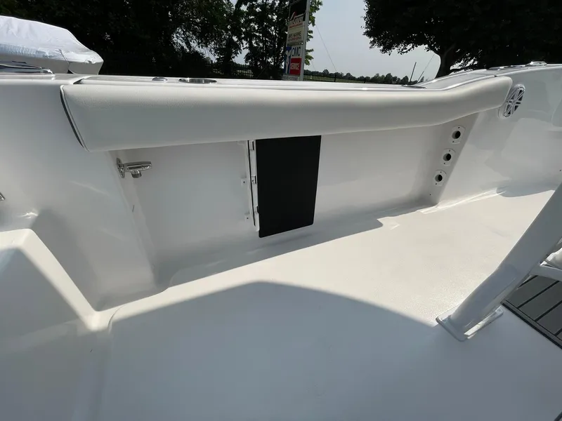Slide: The Image of 2025 Tidewater 232 CC Adventure boat interior, featuring sleek white seating and storage compartments. - 41