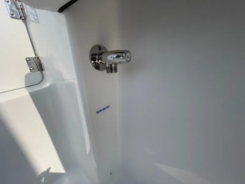 Slide: The Image of 2025 Tidewater 232 CC Adventure boat raw water faucet detail. - 42