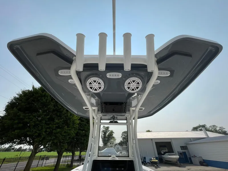 Slide: The Image of 2025 Tidewater 232 CC Adventure boat T-top with rod holders and speakers. - 44