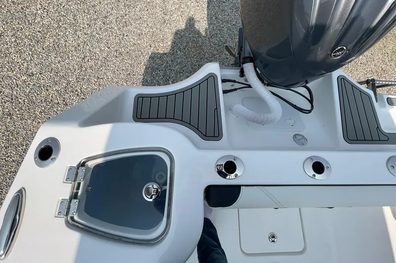 Slide: The Image of Tidewater 232 CC Adventure 2026, boat deck view with motor and rod holders. - 49