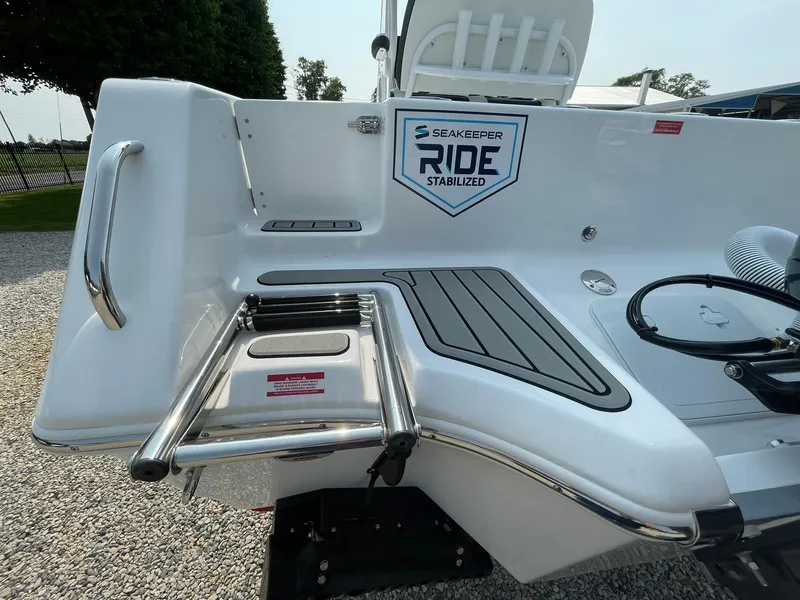 Slide: The Image of 2025 Tidewater 232 CC Adventure boat with Seakeeper Ride Stabilized system and swim ladder. - 54