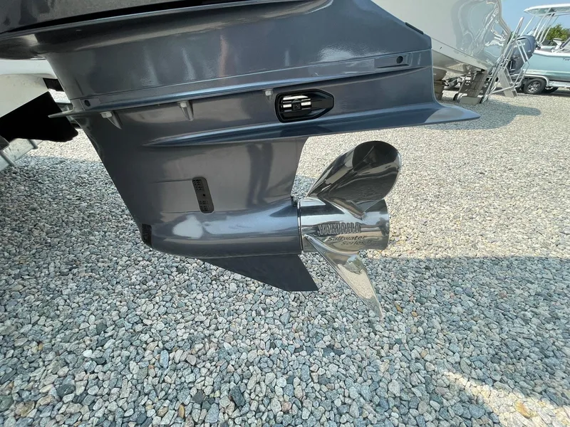 Slide: The Image of 2025 Tidewater 232 CC Adventure boat propeller on gravel surface. - 56