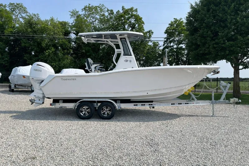 Slide: The Image of 2026 Tidewater 232 CC Adventure boat on trailer, parked outdoors. - 58