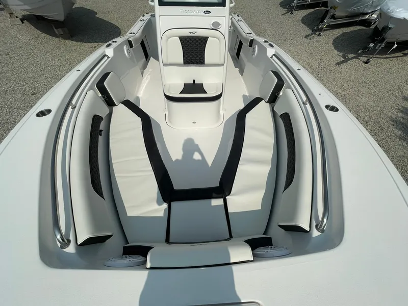 Slide: The Image of 2025 Tidewater 232 CC Adventure boat interior with cushioned seating and sleek design. - 6