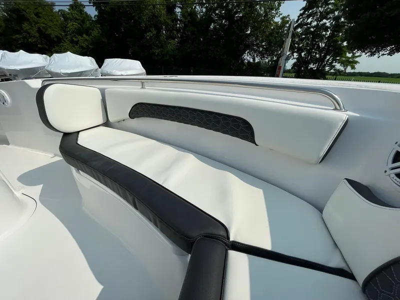 Slide: The Image of 2025 Tidewater 232 CC Adventure boat interior with sleek white and black seating. - 7