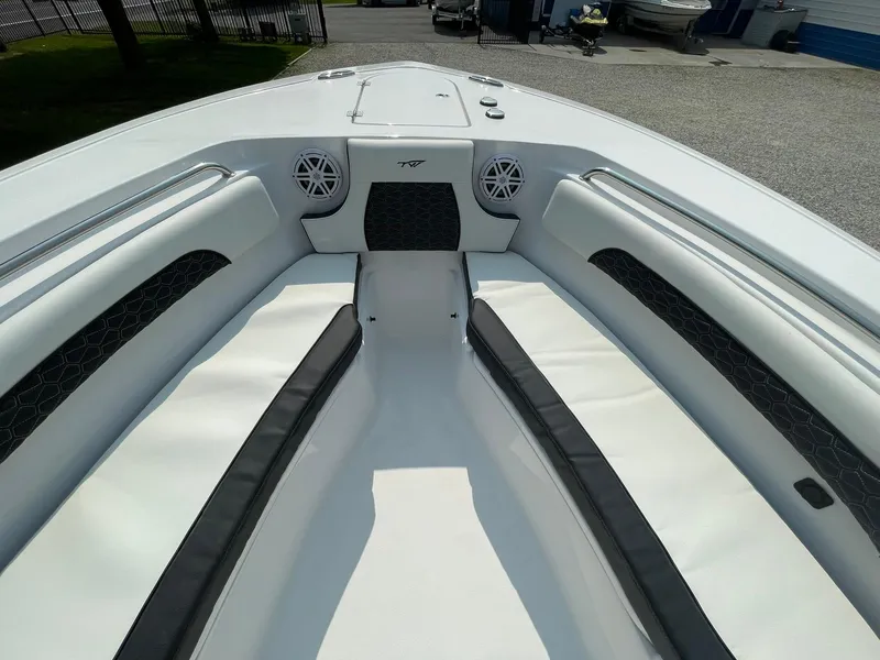 Slide: The Image of 2025 Tidewater 232 CC Adventure boat interior with white seating and speakers. - 9
