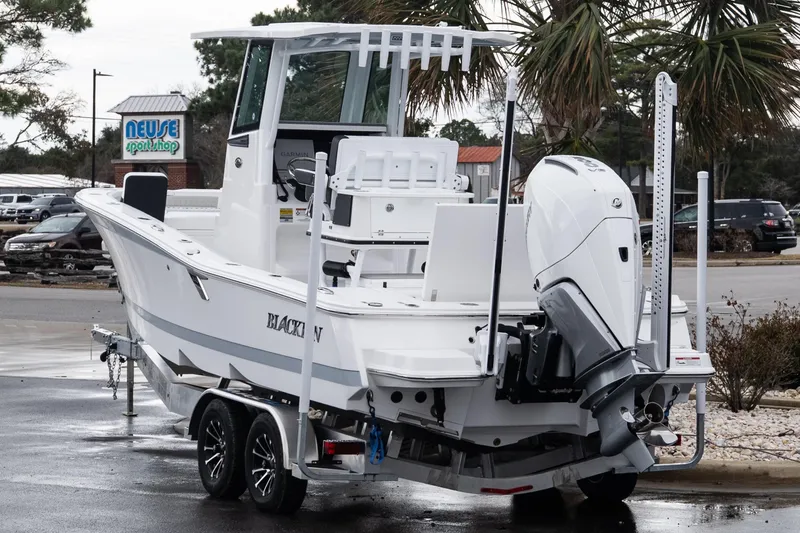 Slide: The Image of 2026 Blackfin 242 HB boat on trailer, parked near Neuse Sport Shop. - 4